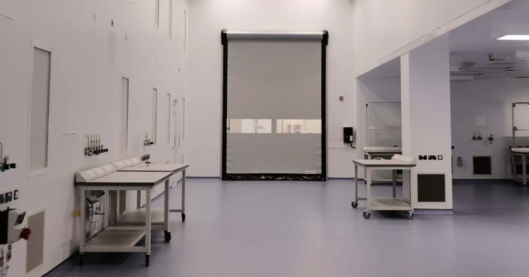 Cleanroom laboratory space with stainless steel benching, observation window and instrumentation for testing or quality control work